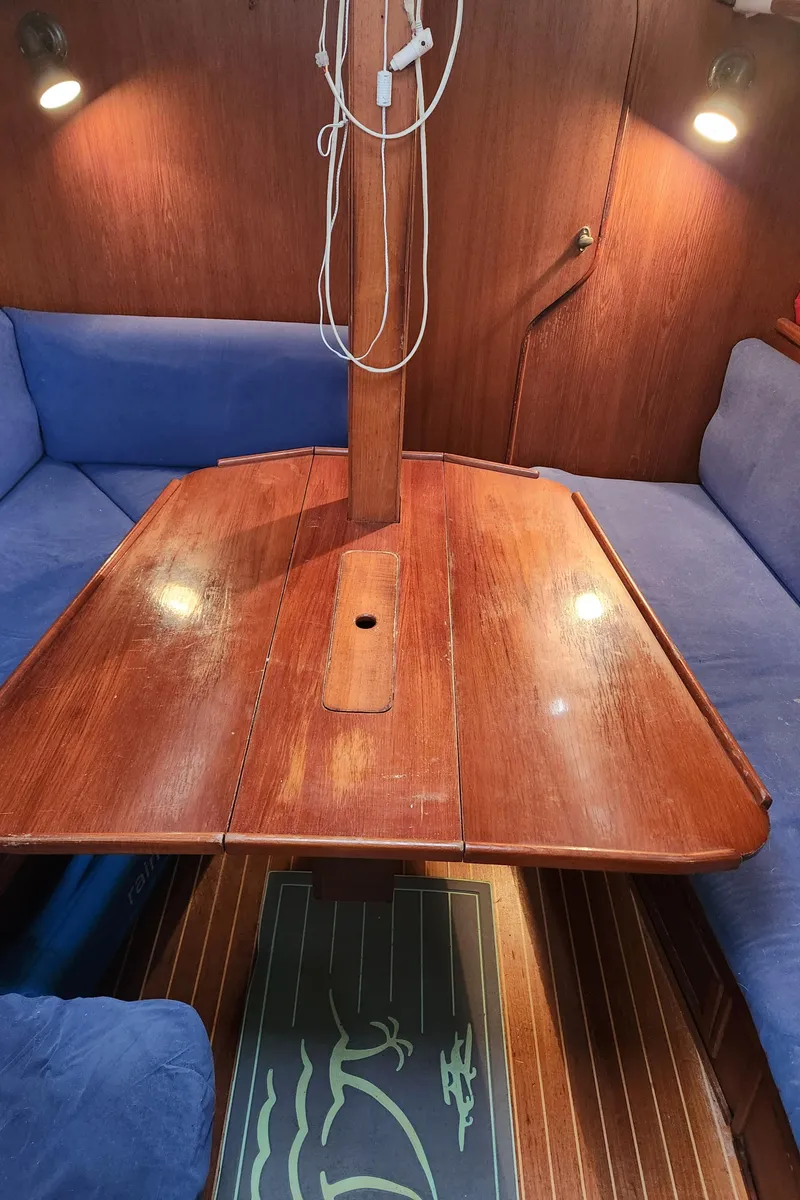 Slide: The Image of Interior of 1989 Granada 375 Atlantica sailboat with wooden table and blue seating. - 26