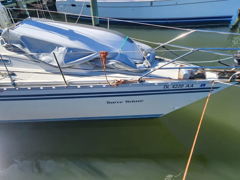 Slide: The Image of 1989 Granada 375 Atlantica sailboat docked, named Barco Relavo, with a covered deck. - 6