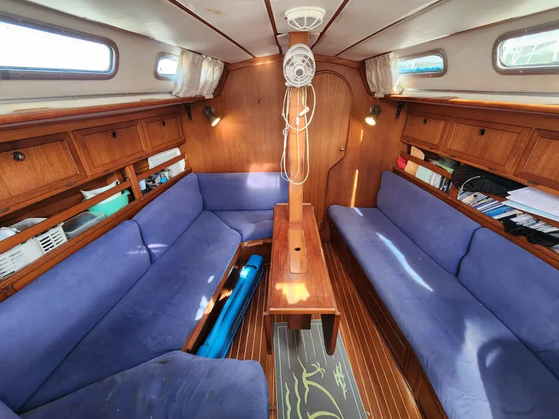 Slide: The Image of Interior of 1989 Granada 375 Atlantica sailboat with blue seating and wooden cabinetry. - 9