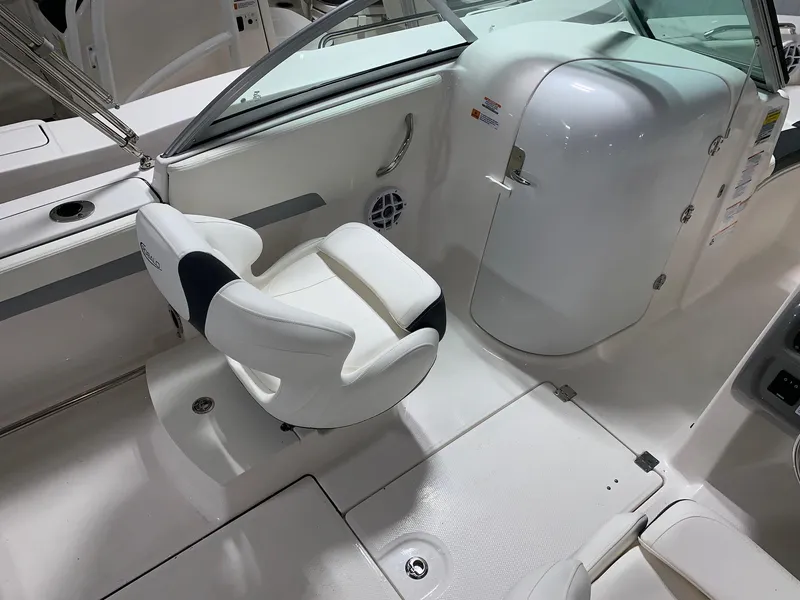 Slide: The Image of 2024 Robalo R207 Dual Console boat interior with white seating and storage compartment. - 12