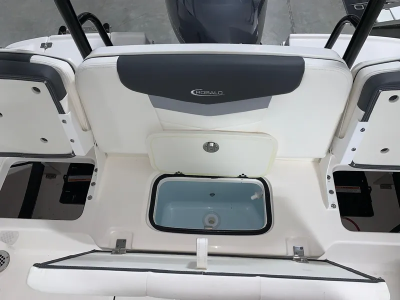 Slide: The Image of 2024 Robalo R207 Dual Console boat interior with storage compartments and seating. - 14