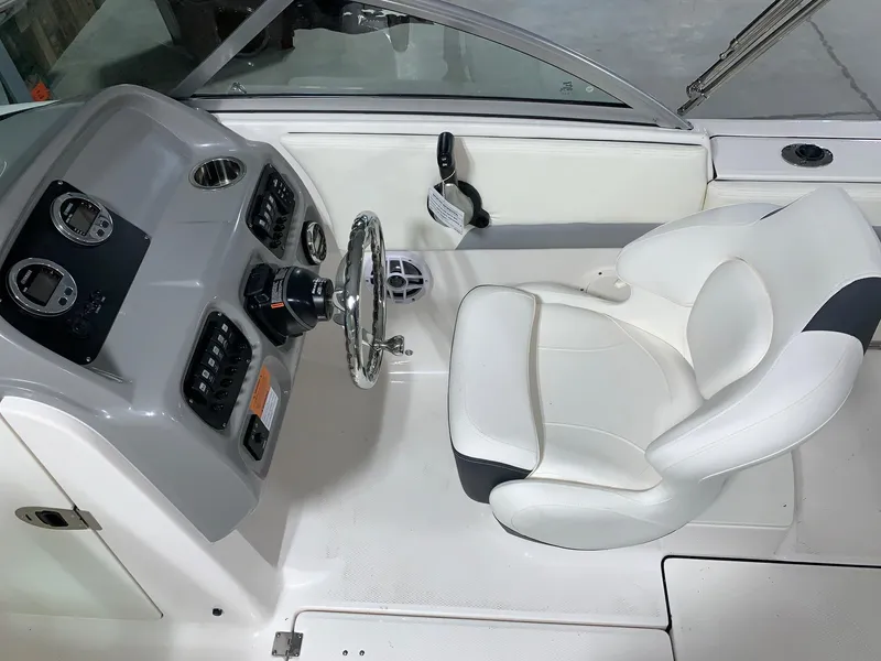 Slide: The Image of 2024 Robalo R207 Dual Console boat cockpit with steering wheel and captain's chair. - 9