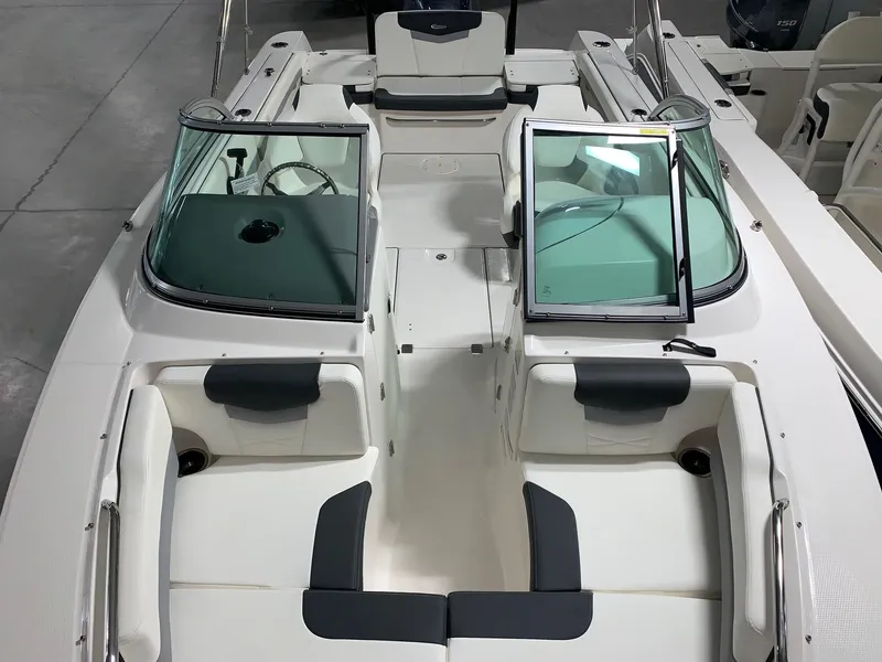 Slide: The Image of 2024 Robalo R207 Dual Console boat interior with seating and windshield. - 5