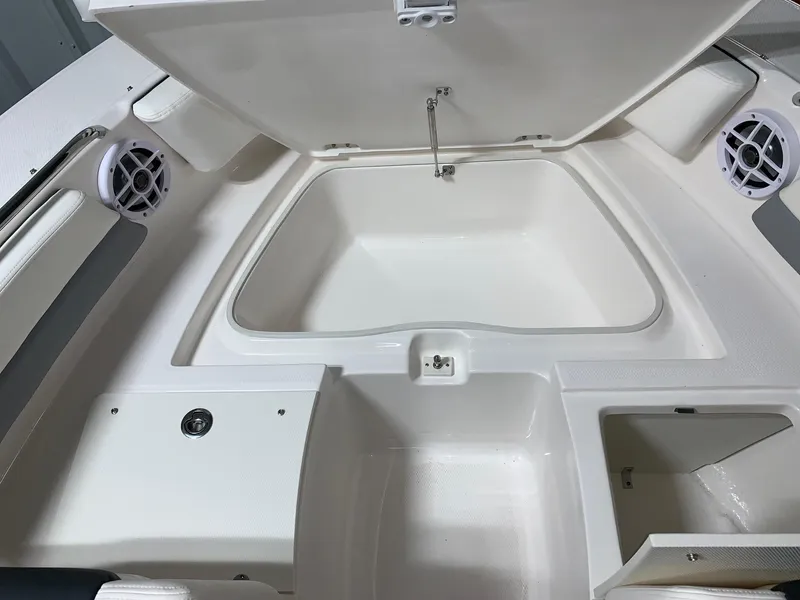 Slide: The Image of 2024 Robalo R207 Dual Console boat storage compartments and seating area. - 6