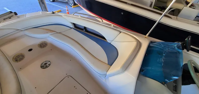 Slide: The Image of 2006 Bayliner 197 SD boat interior with white and blue seating. - 12