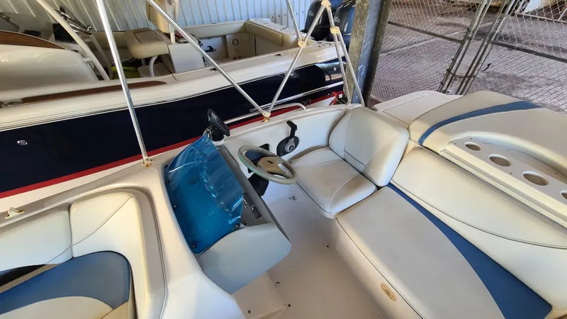 Slide: The Image of 2006 Bayliner 197 SD boat interior with steering wheel and seating. - 13