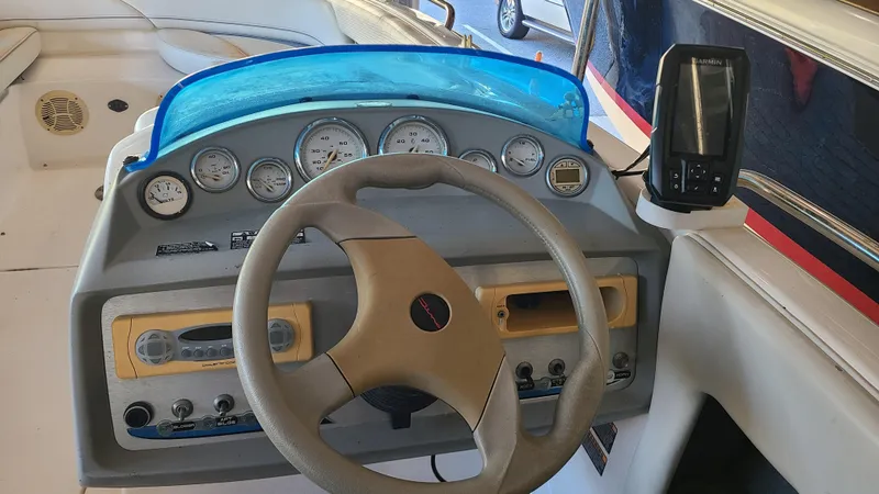 Slide: The Image of 2006 Bayliner 197 SD boat dashboard with steering wheel and instrument panel. - 14