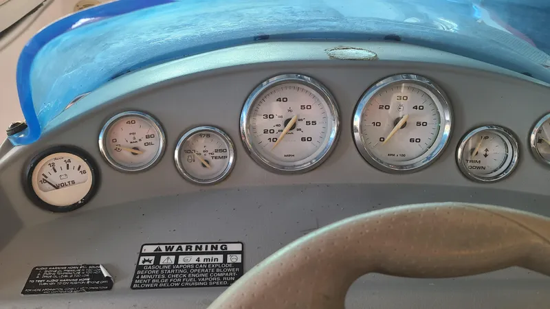 Slide: The Image of Dashboard of a 2006 Bayliner 197 SD boat with gauges and warning labels. - 15