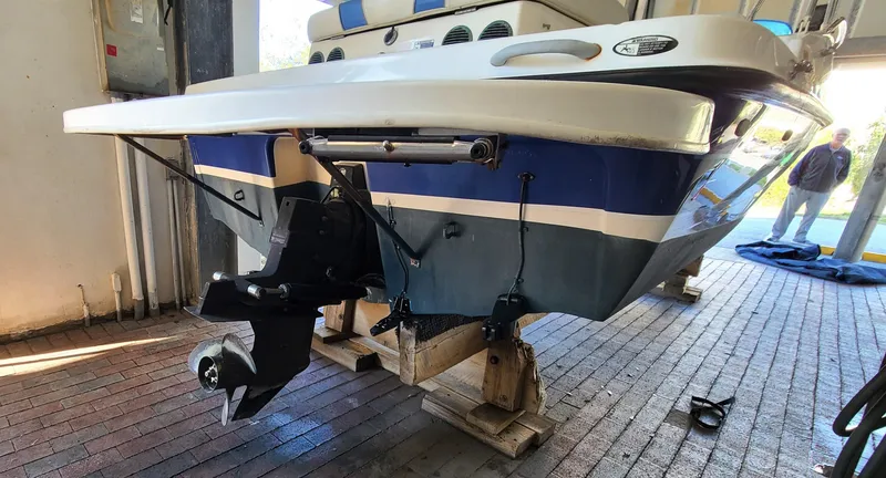 Slide: The Image of 2006 Bayliner 197 SD boat on wooden blocks in a garage. - 2