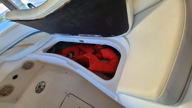 Slide: The Image of Storage compartment with life jackets in a 2006 Bayliner 197 SD boat. - 26