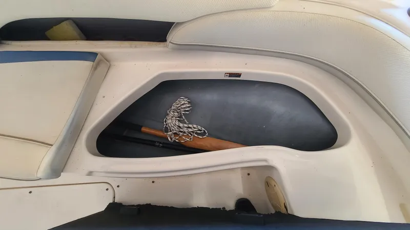 Slide: The Image of Storage compartment of a 2006 Bayliner 197 SD boat with rope and paddle. - 28