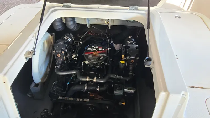 Slide: The Image of 2006 Bayliner 197 SD boat engine compartment with 4.3L Mercury engine. - 30