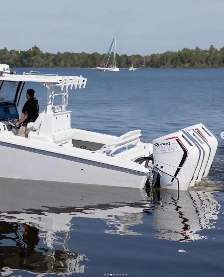 Slide: The Image of 2024 Fountain Bluewater 38 Tournament Edition boat on a calm lake. - 10
