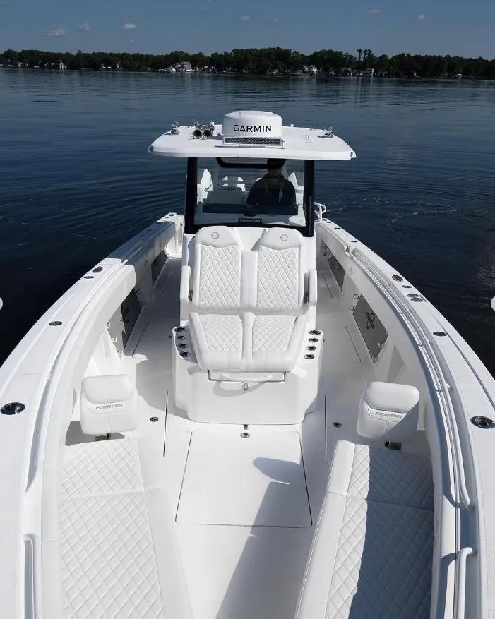 Slide: The Image of 2024 Fountain Bluewater 38 Tournament Edition boat on calm water. - 15