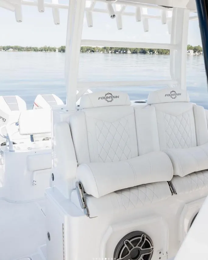Slide: The Image of 2024 Fountain Bluewater 38 Tournament Edition boat interior with white seating. - 16