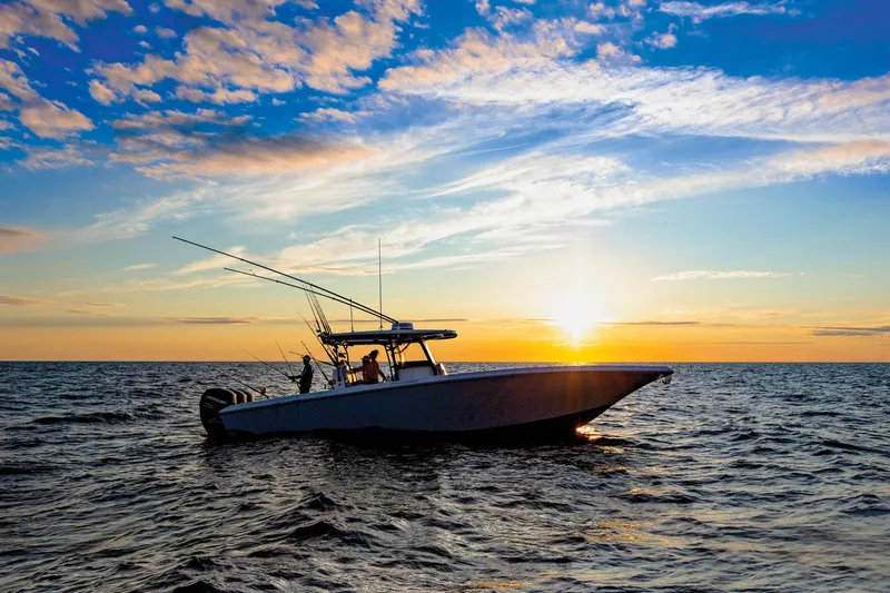 Slide: The Image of 2024 Fountain Bluewater 38 Tournament Edition boat at sunset on the ocean. - 19