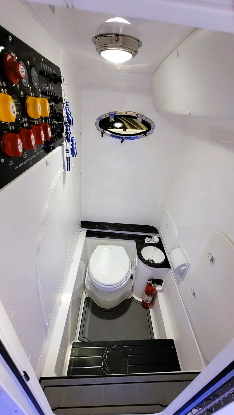 Slide: The Image of 2024 Fountain Bluewater 38 Tournament Edition boat bathroom interior with modern fixtures. - 26
