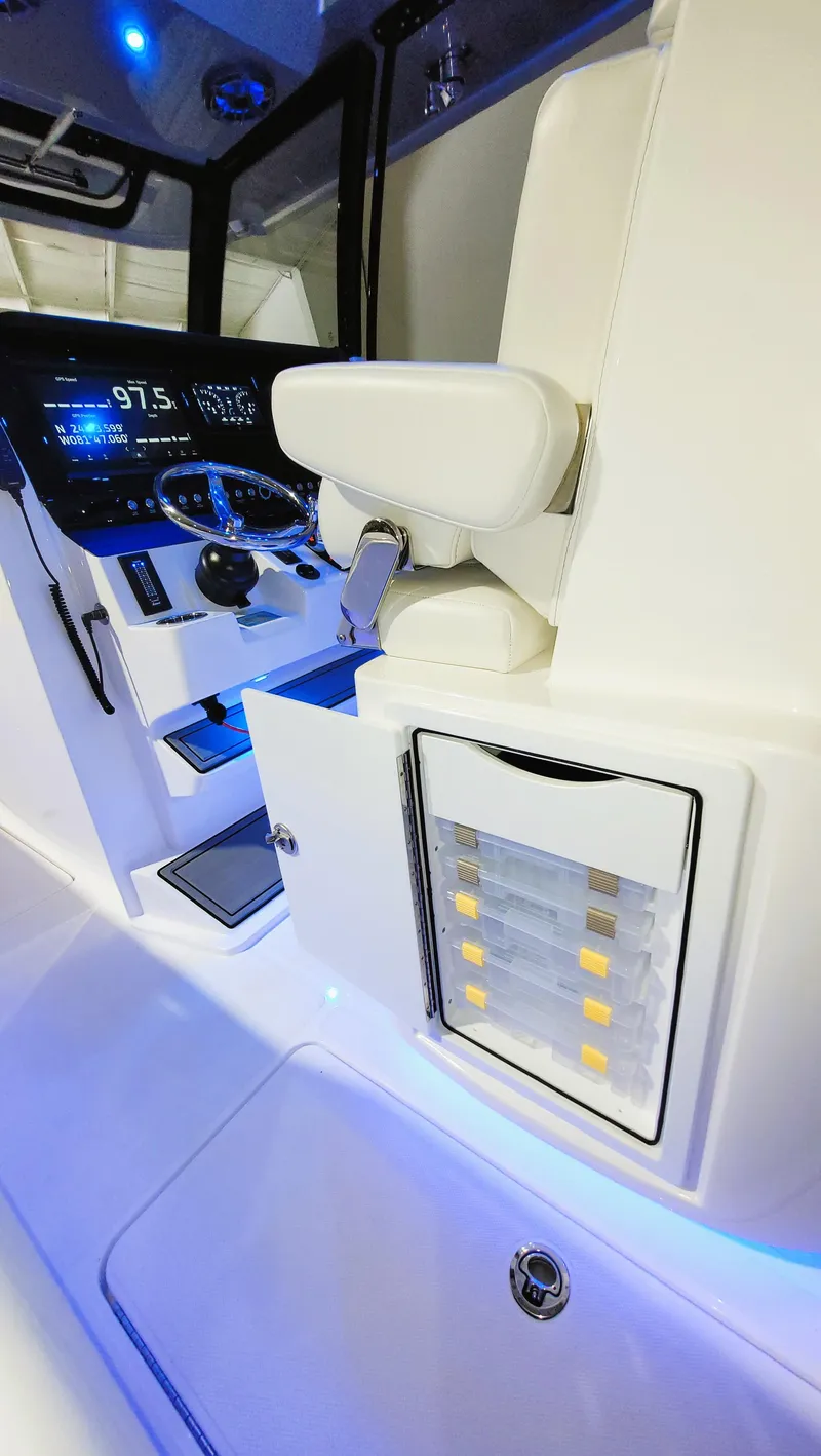 Slide: The Image of 2024 Fountain Bluewater 38 Tournament Edition boat interior with illuminated dashboard and seating. - 27