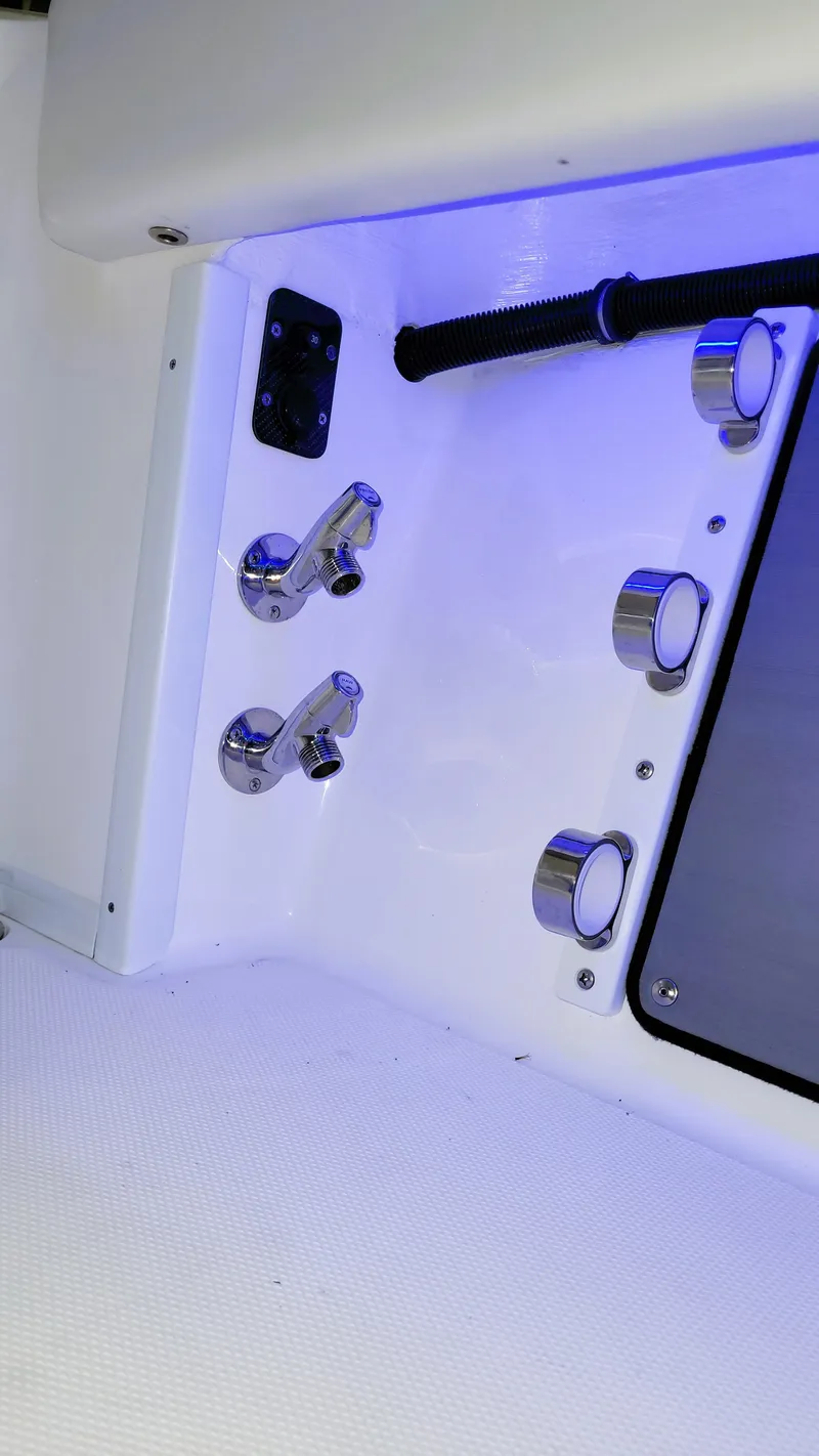 Slide: The Image of 2024 Fountain Bluewater 38 Tournament Edition boat interior with chrome fixtures and blue lighting. - 30