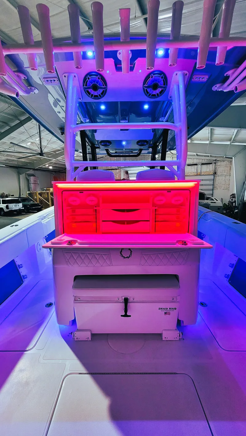 Slide: The Image of 2024 Fountain Bluewater 38 Tournament Edition boat with illuminated interior and fishing setup. - 33