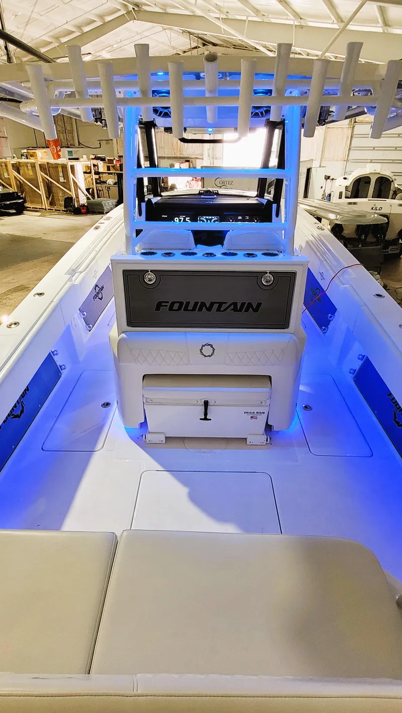 Slide: The Image of 2024 Fountain Bluewater 38 Tournament Edition boat with illuminated interior in a showroom. - 35
