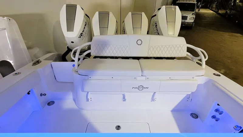 Slide: The Image of 2024 Fountain Bluewater 38 Tournament Edition boat with quad engines and illuminated deck. - 38