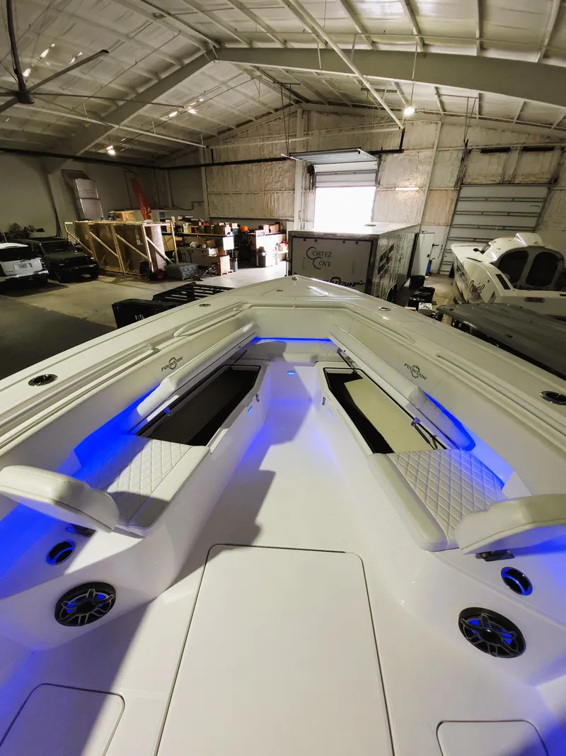 Slide: The Image of 2024 Fountain Bluewater 38 Tournament Edition boat in a warehouse with blue LED lighting. - 40