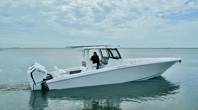 Slide: The Image of 2024 Fountain Bluewater 38 Tournament Edition boat on calm water. - 6