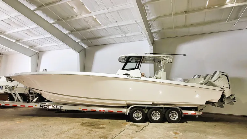 Slide: The Image of 2024 Fountain Bluewater 38 Tournament Edition boat on trailer in warehouse. - 7