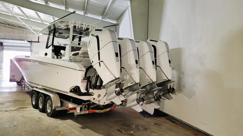 Slide: The Image of 2024 Fountain Bluewater 38 Tournament Edition boat with four powerful outboard engines. - 8