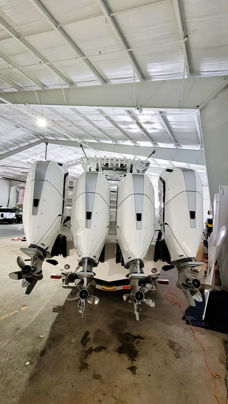 Slide: The Image of 2024 Fountain Bluewater 38 Tournament Edition with four powerful outboard engines in a boat garage. - 9