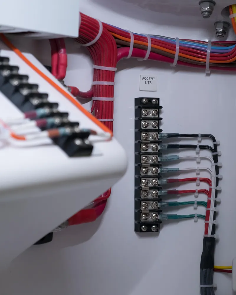 Slide: The Image of Electrical wiring and fuse panel in a 2025 Mag Bay 33 CC boat. - 12