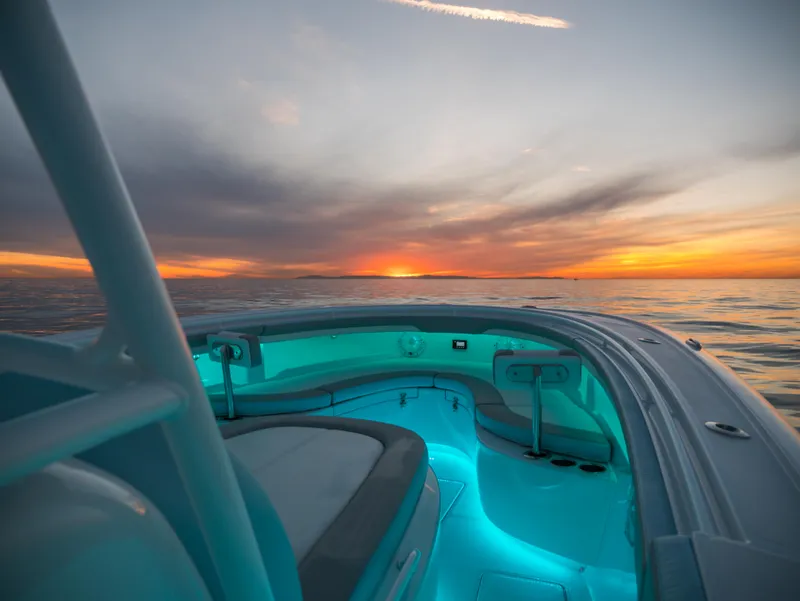 Slide: The Image of 2025 Mag Bay 33 CC boat at sunset with illuminated interior. - 14