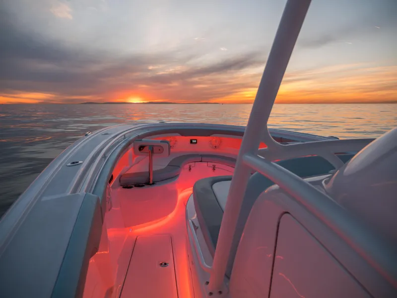 Slide: The Image of 2025 Mag Bay 33 CC boat interior at sunset with ambient lighting. - 18