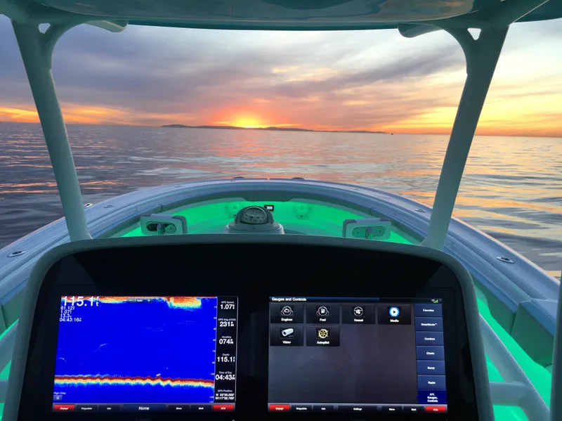 Slide: The Image of Mag Bay 33 CC 2025 boat dashboard at sunset on the open sea. - 41