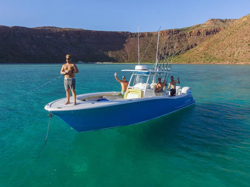 Slide: The Image of 2025 Mag Bay 33 CC boat with people enjoying clear blue waters. - 47