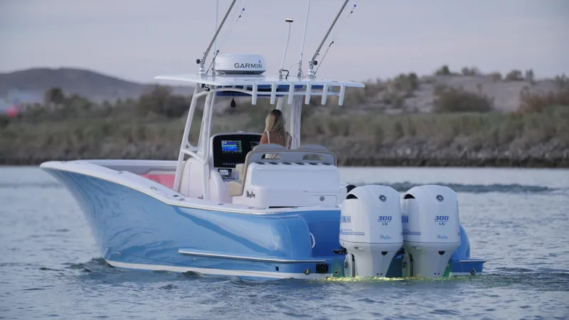 Slide: The Image of 2025 Mag Bay 33 CC boat with dual outboard engines on the water. - 49