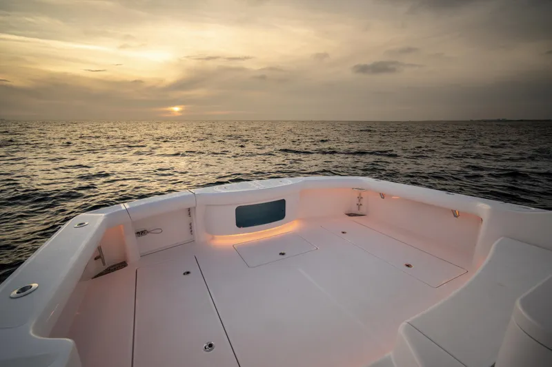 Slide: The Image of Mag Bay 42 boat deck at sunset, 2025 model, ocean view. - 13