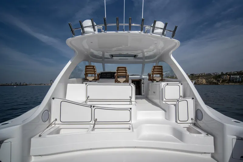 Slide: The Image of 2025 Mag Bay 42 yacht, spacious deck with seating, ocean backdrop. - 14