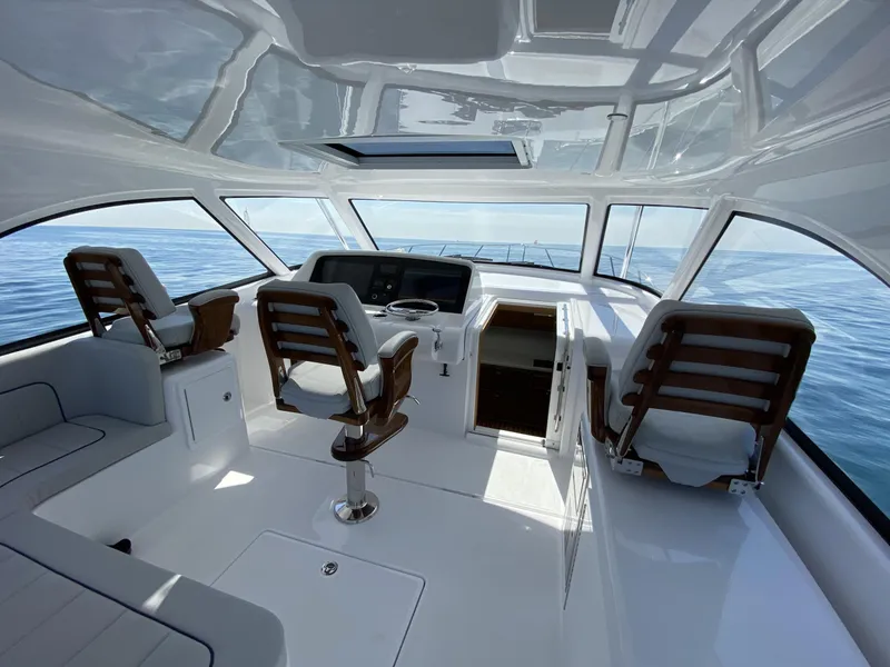 Slide: The Image of Interior of 2025 Mag Bay 42 yacht with modern helm and seating. - 19