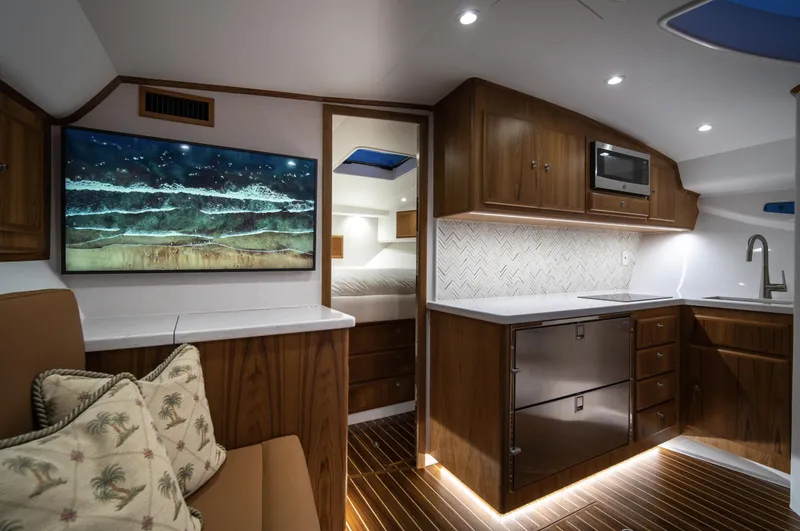 Slide: The Image of Luxurious interior of 2025 Mag Bay 42 yacht with modern kitchen and cozy seating area. - 23