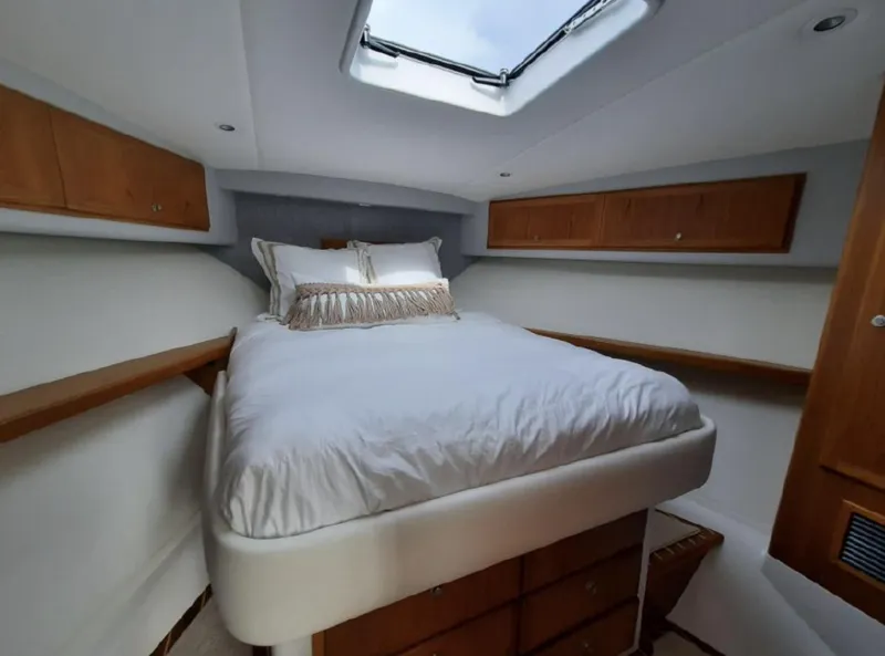 Slide: The Image of Luxurious bedroom interior of 2025 Mag Bay 42 yacht with skylight and wooden cabinets. - 28