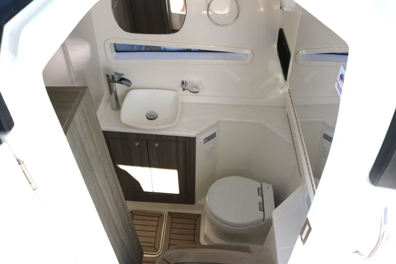 Slide: The Image of 2023 World Cat 400DC-X boat interior bathroom with sink, toilet, and mirror. - 12