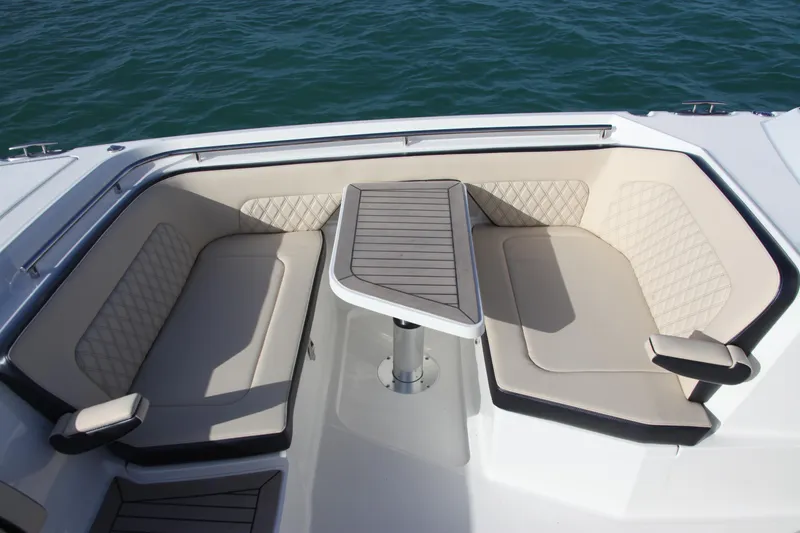 Slide: The Image of 2023 World Cat 400DC-X boat seating area with table on the water. - 20