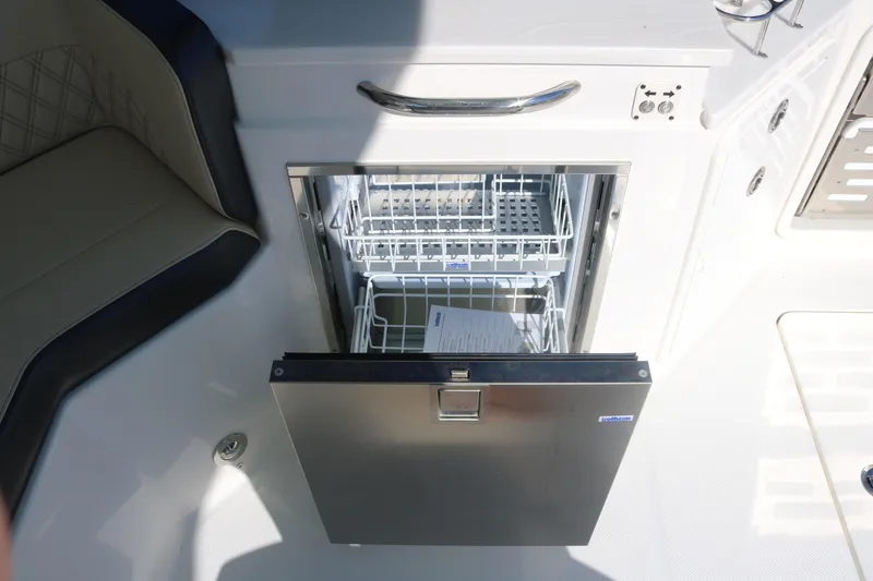 Slide: The Image of 2023 World Cat 400DC-X boat with built-in dishwasher in the cockpit area. - 27