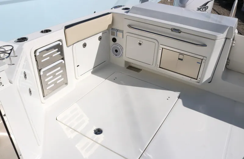 Slide: The Image of 2023 World Cat 400DC-X boat deck with storage compartments and seating. - 29