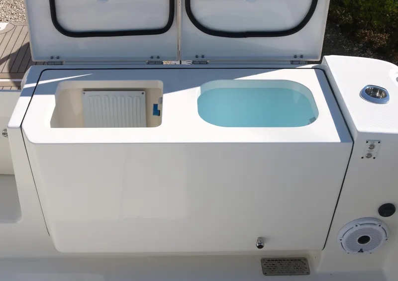 Slide: The Image of 2023 World Cat 400DC-X boat with open storage compartments. - 32