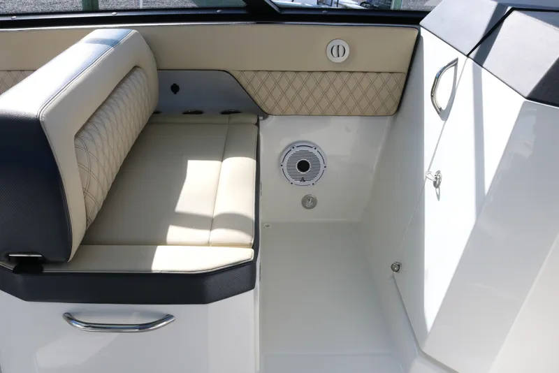 Slide: The Image of Interior seating area of 2023 World Cat 400DC-X boat with beige and black upholstery. - 9