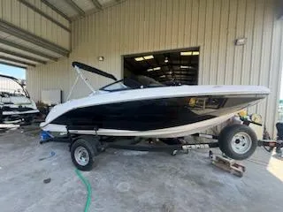 The Image of 2017 Scarab 195 boat on a trailer in a storage facility. - 0