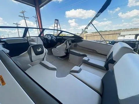 Slide: The Image of 2017 Scarab 195 boat interior with seating and steering wheel under a blue sky. - 10